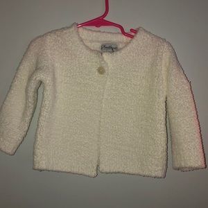 White sweater with button closure and matching hat